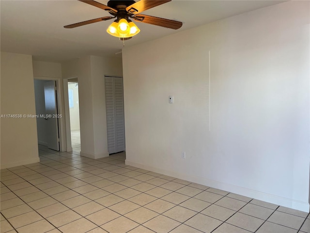 tiled spare room with ceiling fan