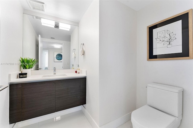 bathroom featuring baseboards, visible vents, vanity, and toilet