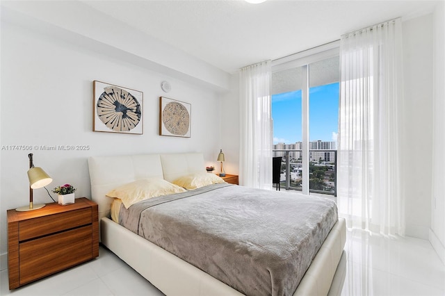 bedroom featuring expansive windows, a view of city, and tile patterned floors