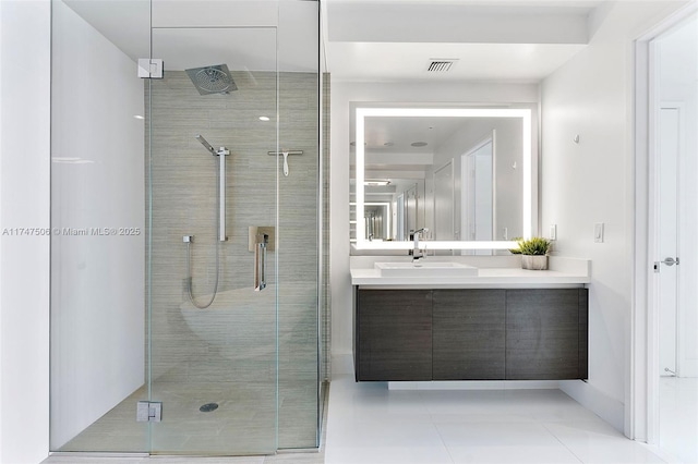 bathroom featuring a stall shower, visible vents, vanity, and tile patterned floors