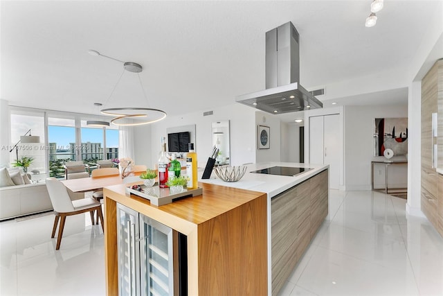 kitchen with black electric cooktop, island range hood, beverage cooler, open floor plan, and modern cabinets