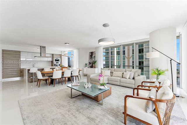 living area with a wall of windows and tile patterned flooring