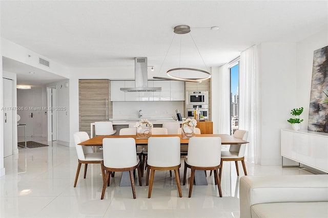 dining room with visible vents and light tile patterned flooring