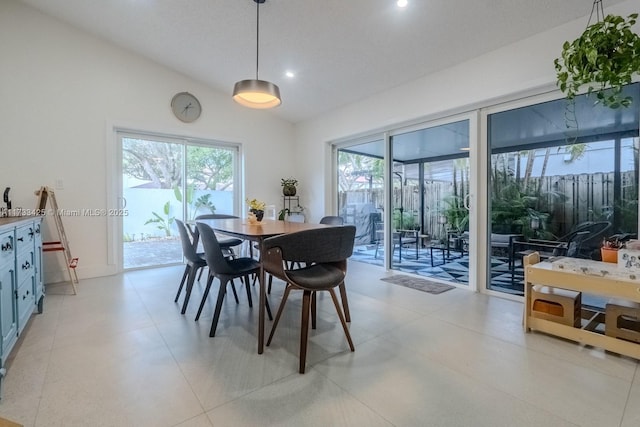 dining space with plenty of natural light and lofted ceiling