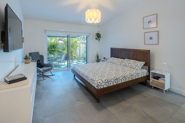 bedroom with access to exterior and lofted ceiling