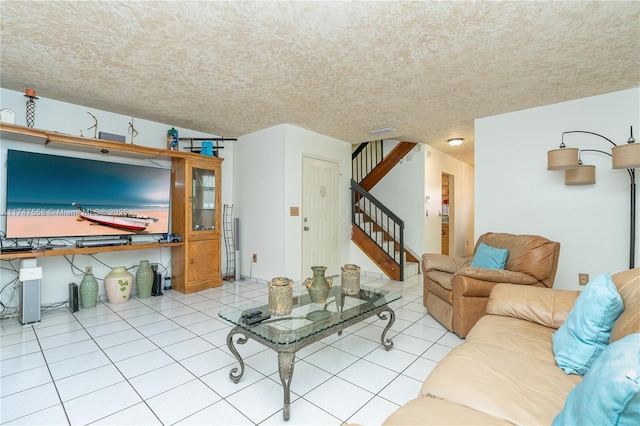 living room with light tile patterned flooring and a textured ceiling