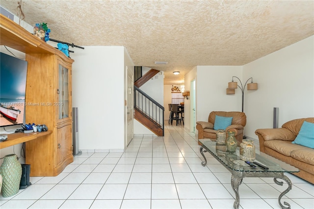 tiled living room featuring a textured ceiling