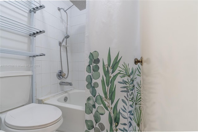 bathroom featuring shower / bath combo with shower curtain and toilet