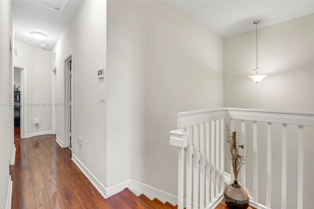 corridor with dark hardwood / wood-style flooring