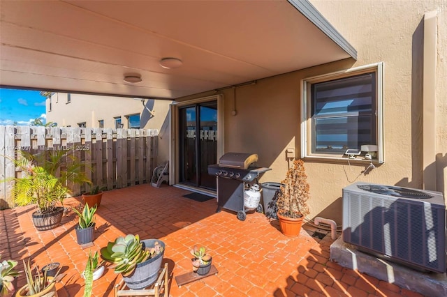 view of patio featuring cooling unit and a grill