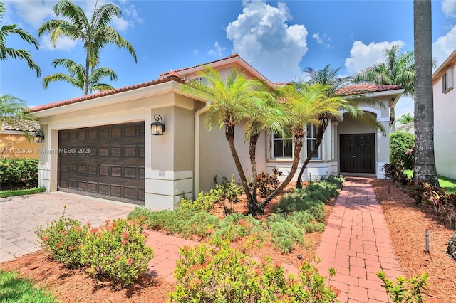 1632 NE Winterberry Ln, Weston, FL 33327 - mediterranean / spanish-style house with a garage, driveway, a tiled roof, and stucco siding