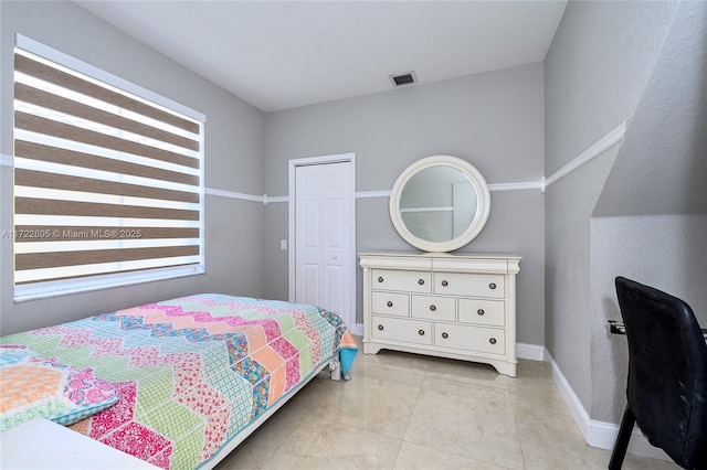 1632 NE Winterberry Ln, Weston, FL 33327 - bedroom with baseboards, visible vents, a closet, and light tile patterned flooring
