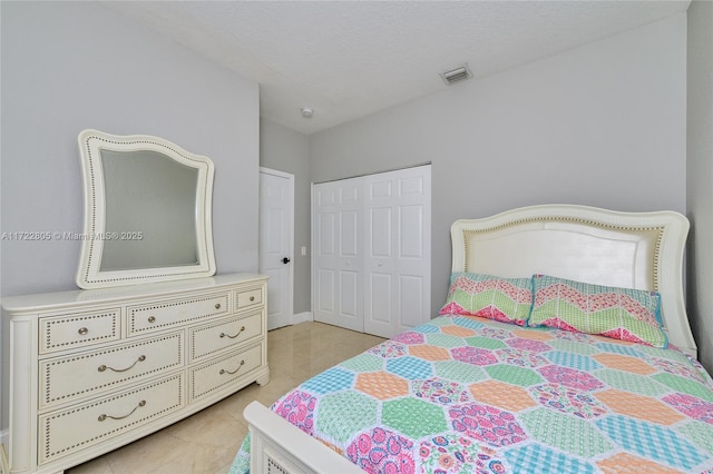 1632 NE Winterberry Ln, Weston, FL 33327 - bedroom featuring a closet, visible vents, a textured ceiling, and light tile patterned flooring