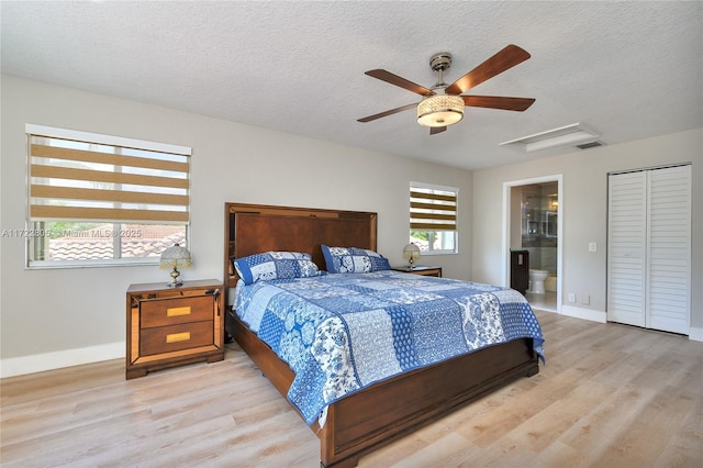 1632 NE Winterberry Ln, Weston, FL 33327 - bedroom featuring a textured ceiling, light wood-style flooring, visible vents, baseboards, and attic access