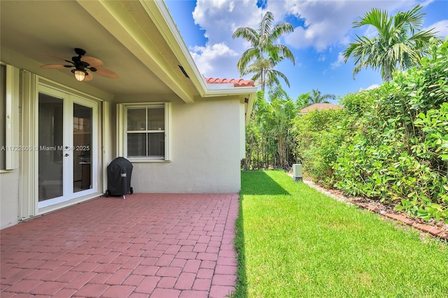 1632 NE Winterberry Ln, Weston, FL 33327 - view of yard featuring french doors, a patio area, and a ceiling fan