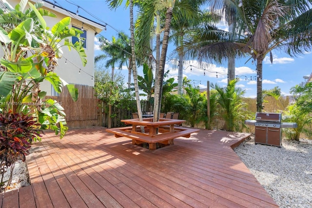 deck featuring fence, outdoor dining area, and area for grilling