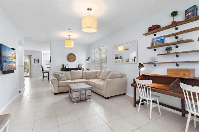 living room featuring light tile patterned floors, baseboards, and visible vents