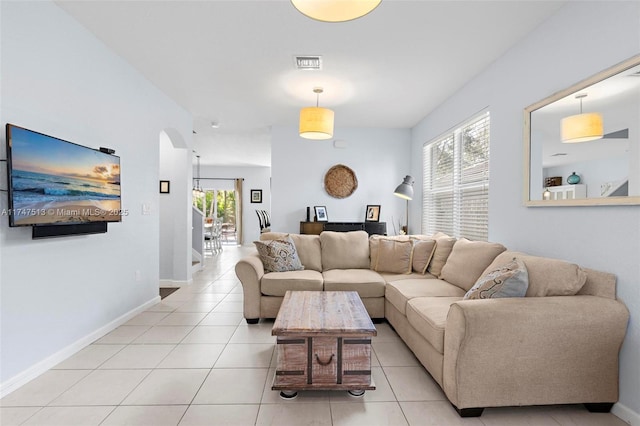 living area with a healthy amount of sunlight, visible vents, and light tile patterned floors