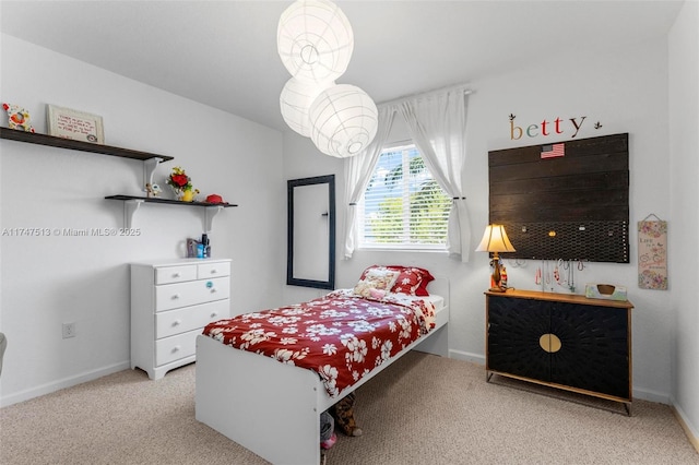 bedroom with carpet flooring and baseboards
