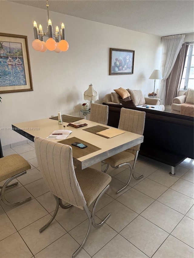 dining room featuring a notable chandelier, light tile patterned flooring, and a textured ceiling