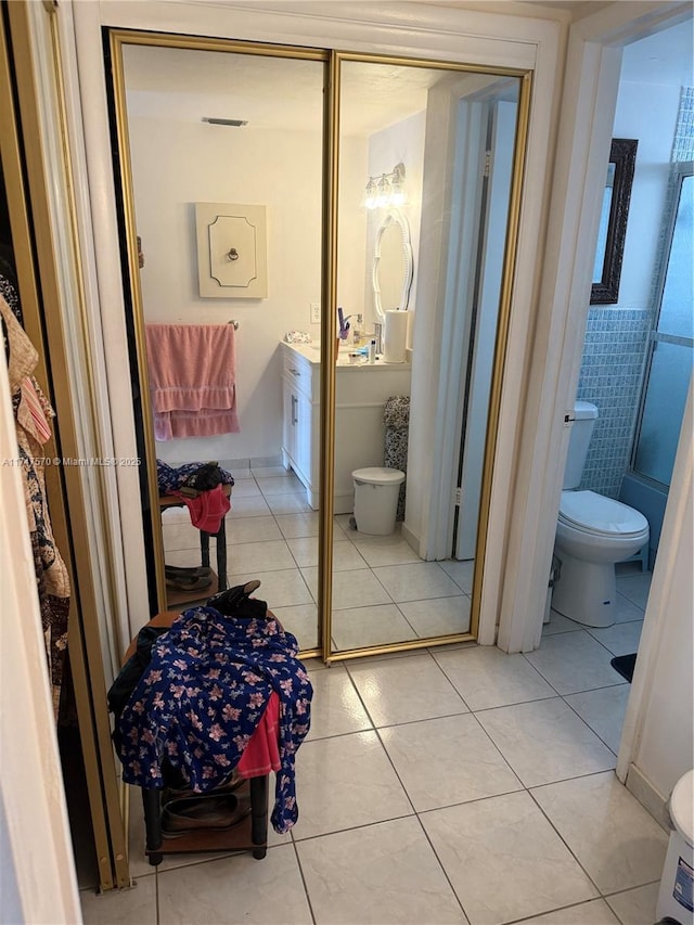 bathroom featuring vanity, toilet, and tile patterned floors