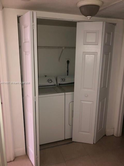 8353 Lake Dr Unit 302, Doral, FL 33166 - clothes washing area featuring washing machine and dryer and light tile patterned floors