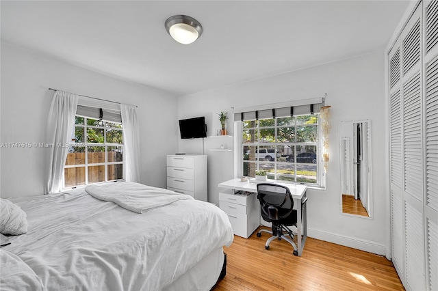 bedroom featuring light wood-type flooring and baseboards