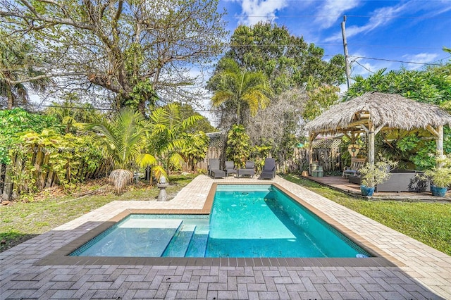 outdoor pool featuring a patio area, a fenced backyard, and a gazebo