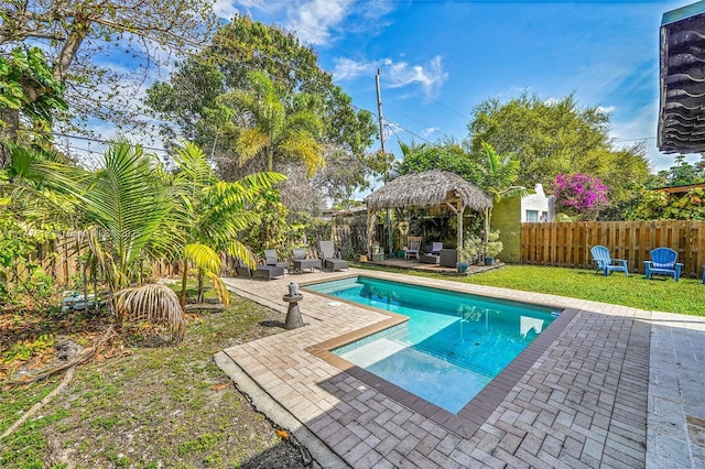 view of swimming pool with a fenced in pool, a patio area, a fenced backyard, and a gazebo