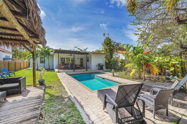 view of pool with a fenced in pool, a patio, a fenced backyard, an outdoor hangout area, and a pergola