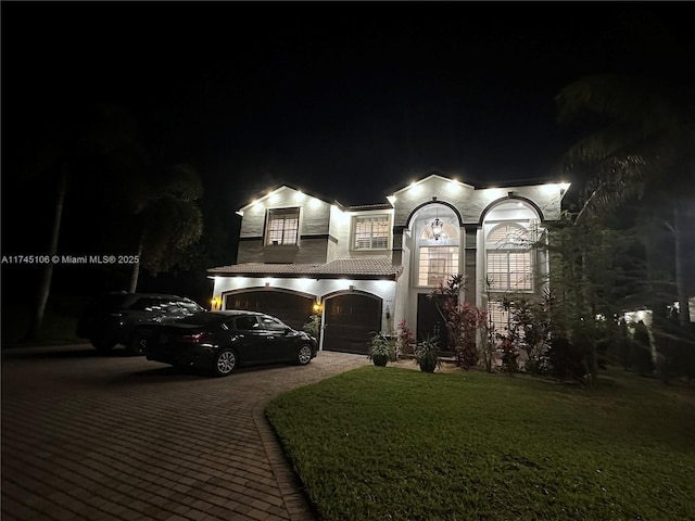 view of front facade featuring a yard and a garage