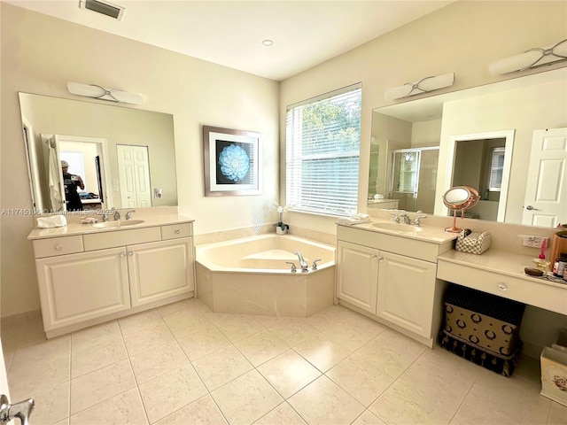 bathroom with plus walk in shower, tile patterned flooring, and vanity