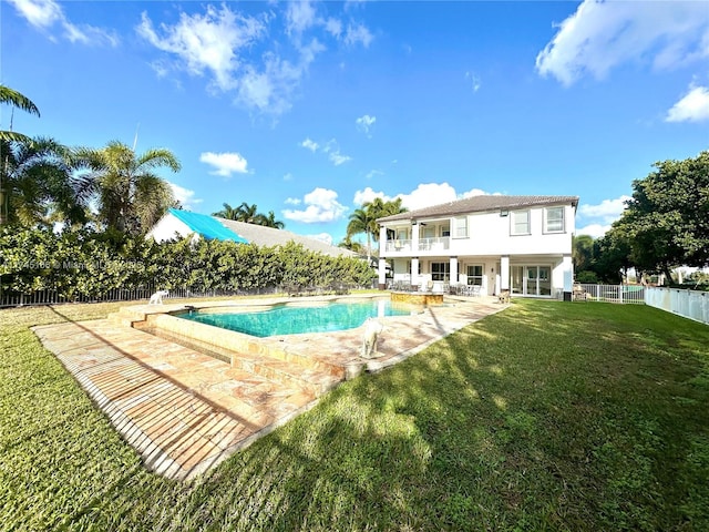 view of pool with a patio area and a lawn