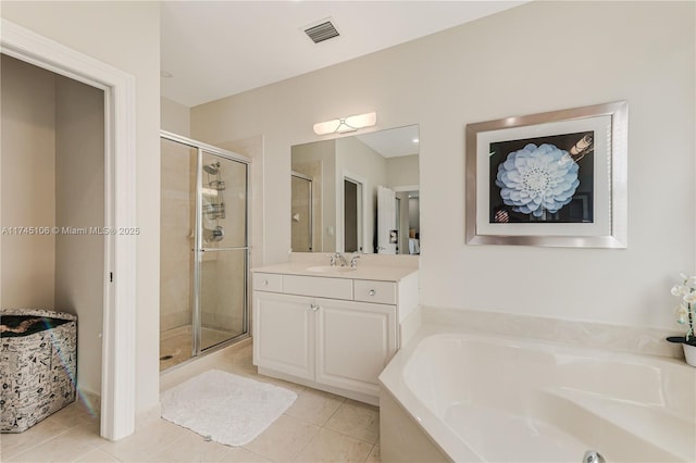 bathroom with separate shower and tub, vanity, and tile patterned flooring