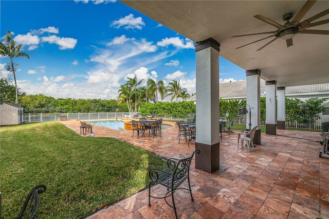 view of patio / terrace with ceiling fan and a fenced in pool