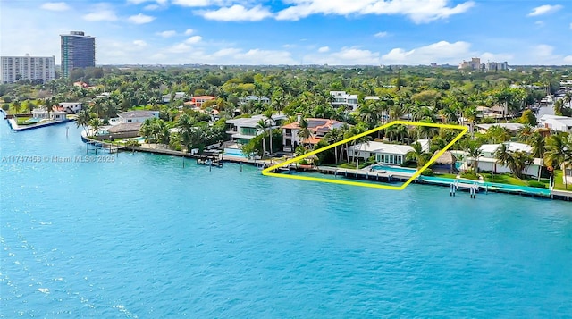 birds eye view of property with a water view and a city view