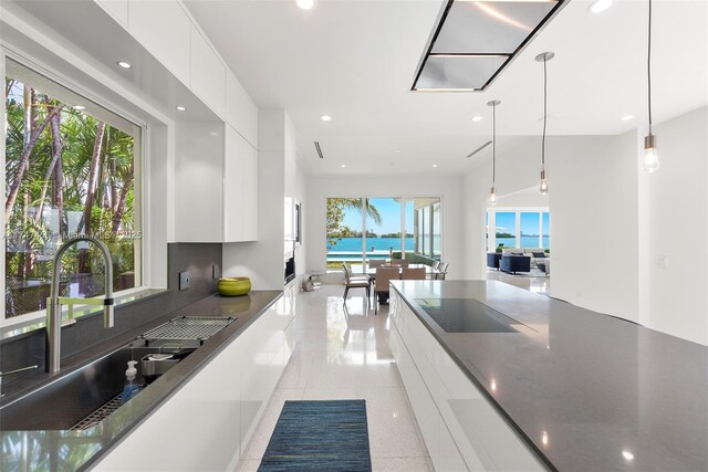 7331 Belle Meade Island Dr, Miami, FL 33138 - kitchen featuring modern cabinets, black electric stovetop, white cabinetry, recessed lighting, and a sink