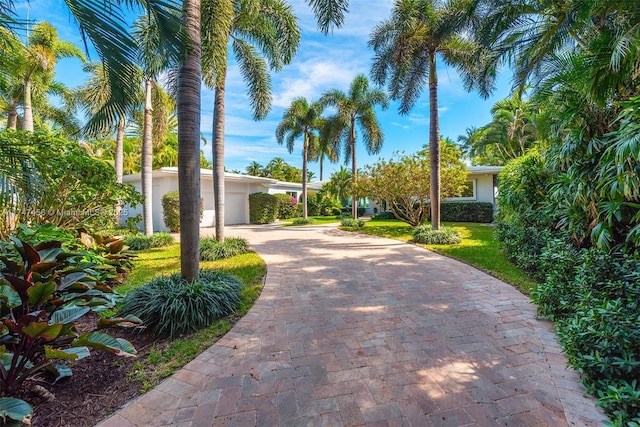 7331 Belle Meade Island Dr, Miami, FL 33138 - view of front of house with decorative driveway, a front yard, and a garage