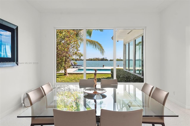 7331 Belle Meade Island Dr, Miami, FL 33138 - dining space featuring baseboards, a water view, and crown molding