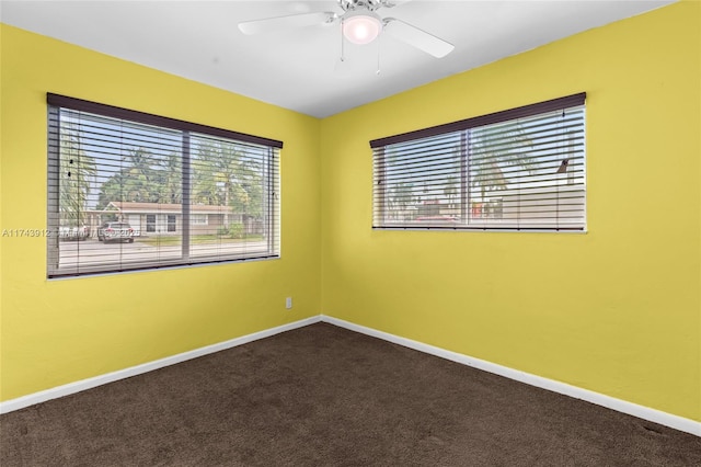 carpeted spare room featuring ceiling fan