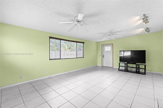 unfurnished living room with light tile patterned floors, ceiling fan, and a textured ceiling