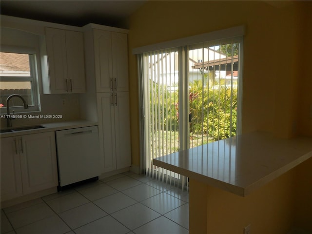 doorway featuring light tile patterned floors, sink, and a healthy amount of sunlight