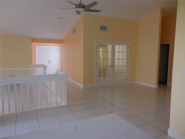 unfurnished room featuring ceiling fan, light tile patterned floors, high vaulted ceiling, and french doors