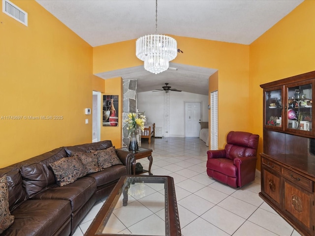 living area with light tile patterned floors, visible vents, ceiling fan with notable chandelier, and vaulted ceiling