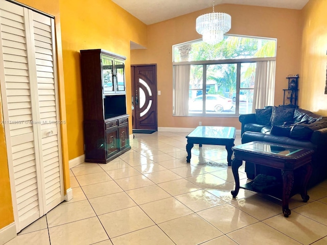 living room with baseboards, a chandelier, and light tile patterned flooring