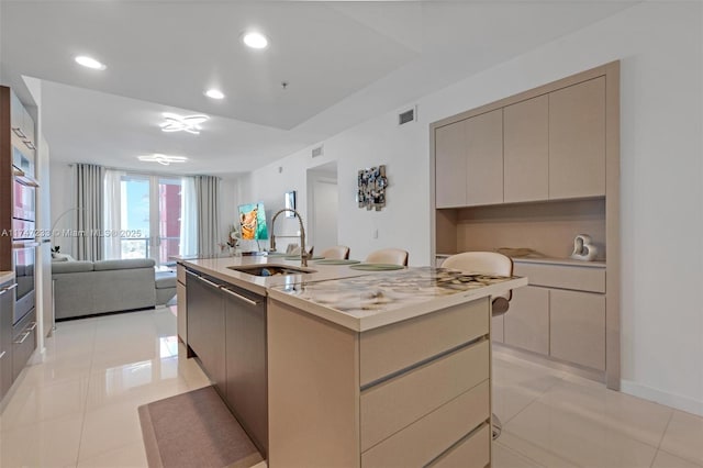 7825 NW 107th Ave Unit 618, Doral, FL 33178 - kitchen with an island with sink, stainless steel double oven, sink, gray cabinets, and light tile patterned flooring