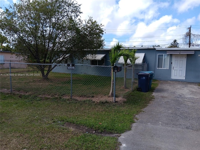 view of side of home featuring a lawn