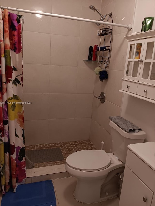 bathroom featuring toilet, vanity, and curtained shower