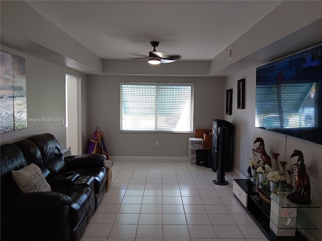 living room featuring light tile patterned flooring and ceiling fan