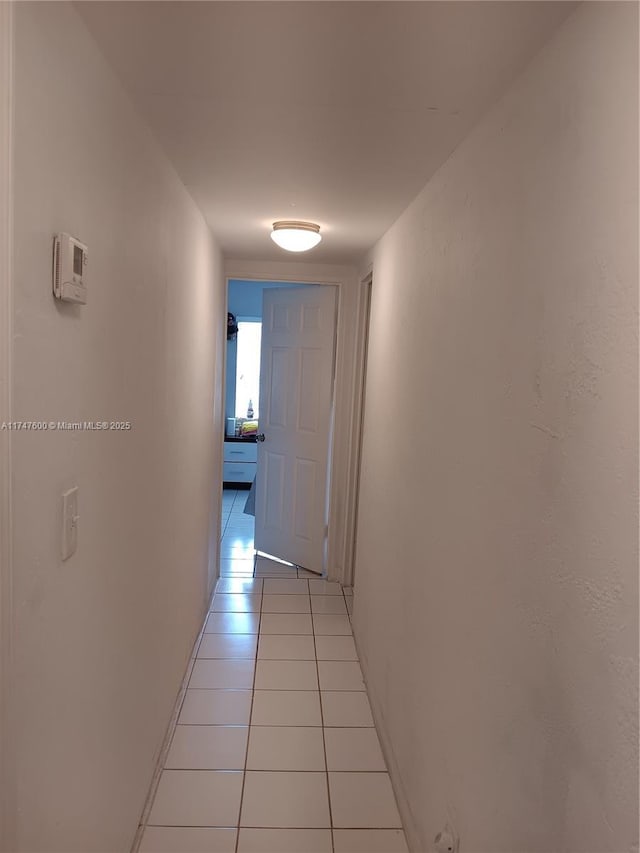 hall with light tile patterned floors